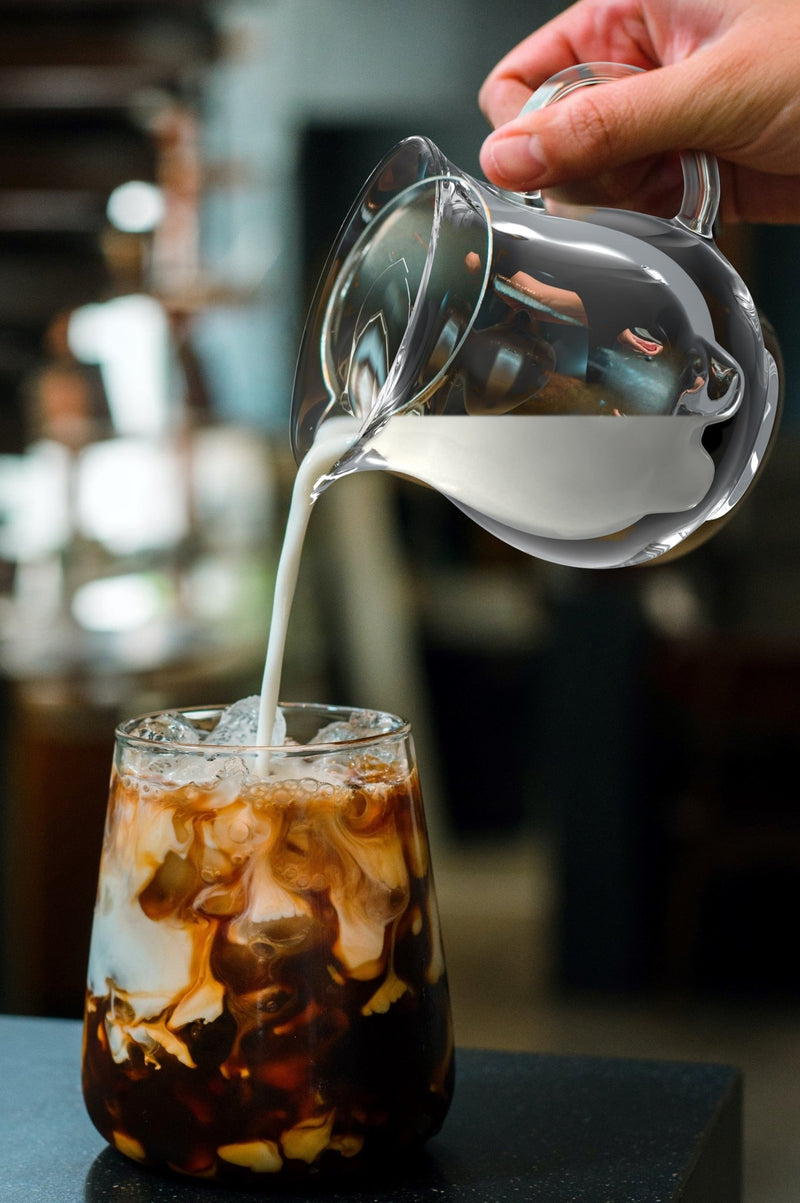 Milk being poured in Iced coffee from Milk Pot Jug